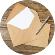 Brown envelope with a white piece of paper and a pen on top