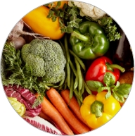 Array of colorful fruits and vegetables including carrots, broccoli, and bell peppers